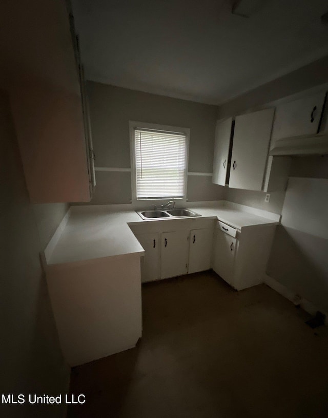 kitchen featuring white cabinetry and sink