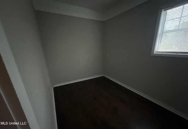 unfurnished room with wood-type flooring