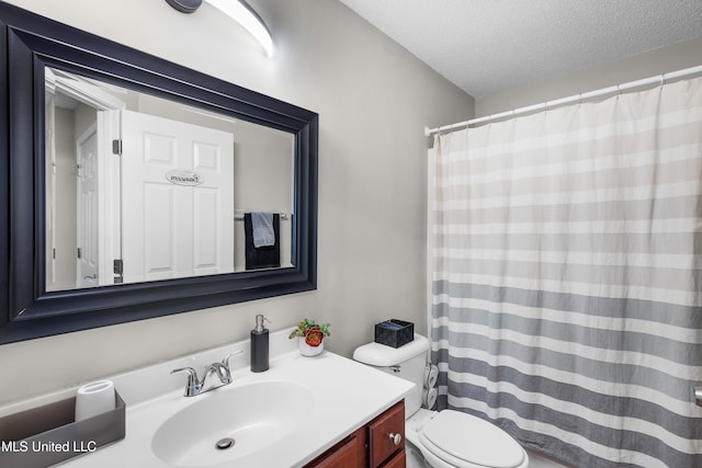 bathroom featuring vanity, a textured ceiling, and toilet