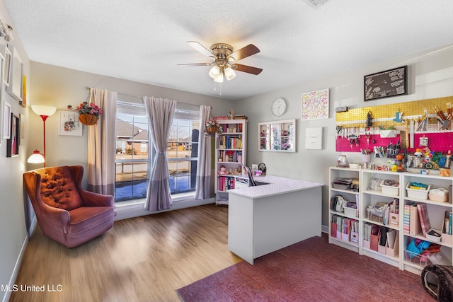 office area featuring ceiling fan, hardwood / wood-style floors, and a textured ceiling