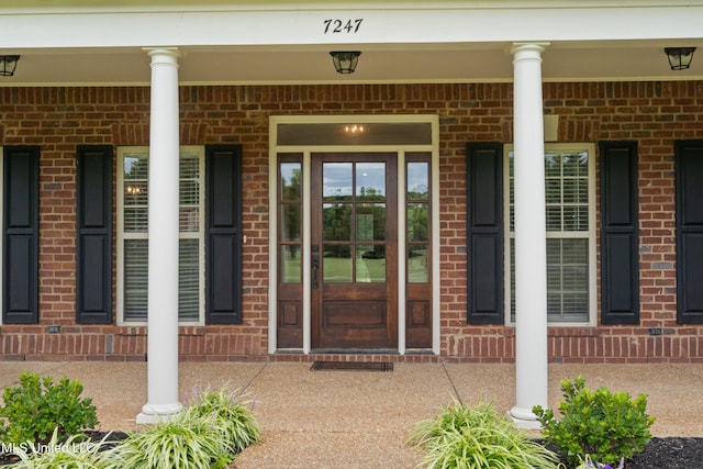 7247 Eastern Rd, Olive Branch, MS 38654 - view of exterior entry with a porch and brick siding