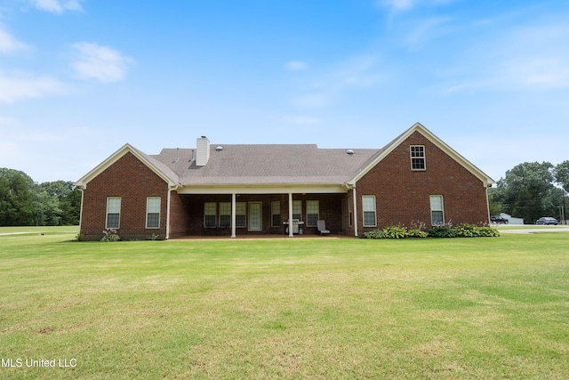 7247 Eastern Rd, Olive Branch, MS 38654 - rear view of property with brick siding, a lawn, and a chimney