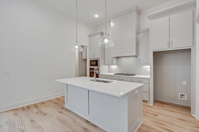 961 Mullican Rd, Florence, MS 39073 - kitchen with ornamental molding, a sink, tasteful backsplash, stainless steel appliances, and light wood-style flooring