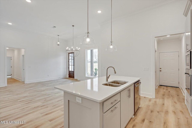 961 Mullican Rd, Florence, MS 39073 - kitchen featuring a sink, appliances with stainless steel finishes, light wood-style flooring, ornamental molding, and a chandelier