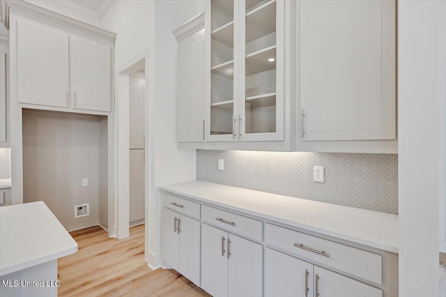 961 Mullican Rd, Florence, MS 39073 - kitchen featuring backsplash, glass insert cabinets, and light countertops