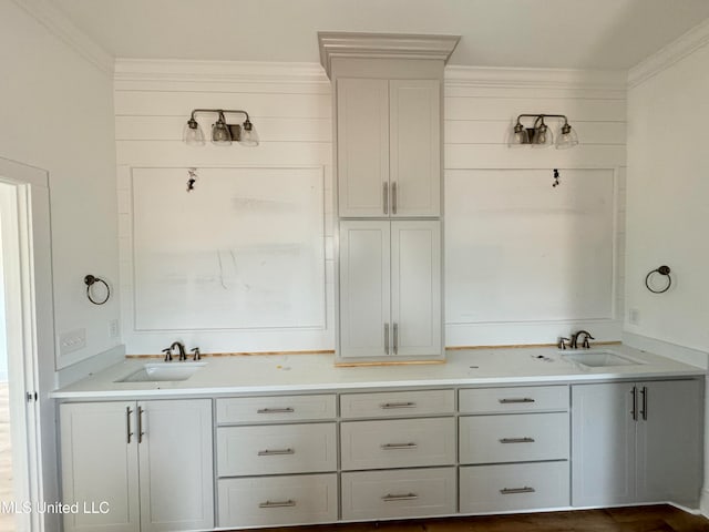 full bath with double vanity, ornamental molding, and a sink