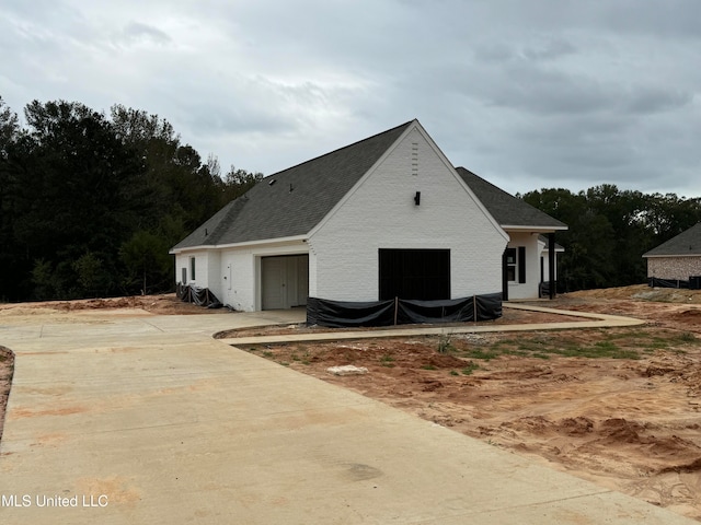 view of side of property featuring a garage