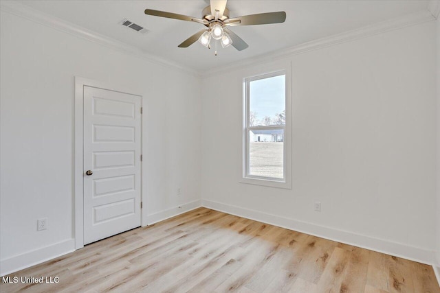 unfurnished room featuring a ceiling fan, baseboards, visible vents, light wood-type flooring, and crown molding