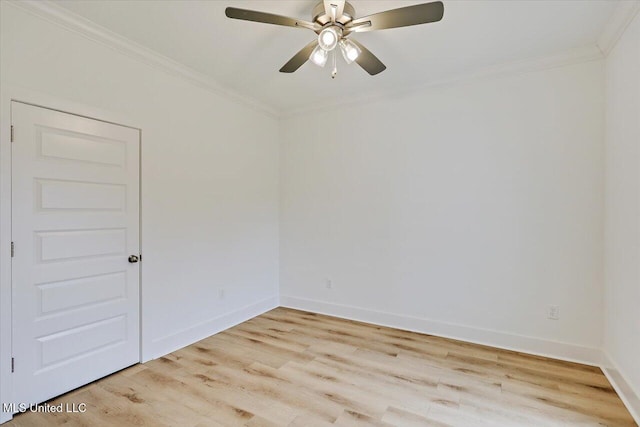 spare room featuring ornamental molding, light wood-style flooring, and baseboards