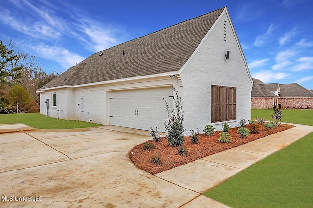 961 Mullican Rd, Florence, MS 39073 - view of home's exterior featuring a garage, a yard, a shingled roof, and concrete driveway