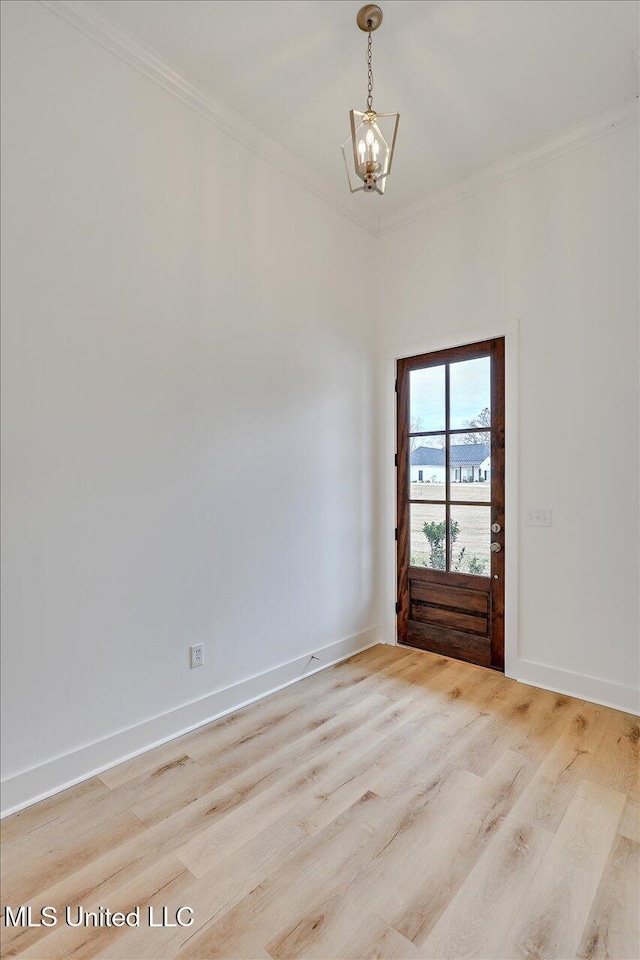 961 Mullican Rd, Florence, MS 39073 - spare room with a chandelier, ornamental molding, light wood-style flooring, and baseboards