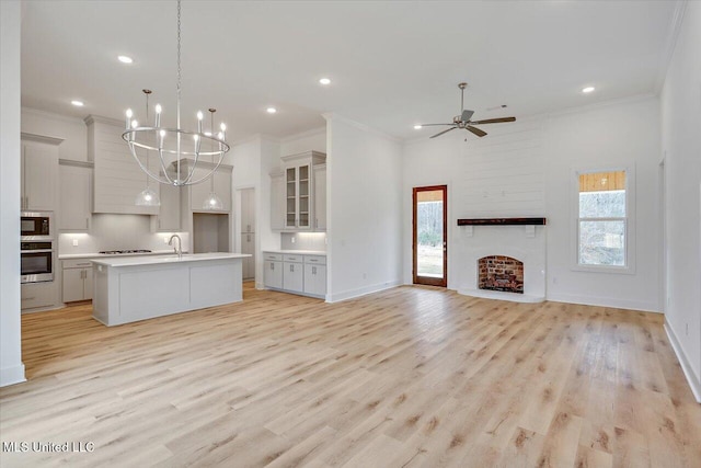 961 Mullican Rd, Florence, MS 39073 - kitchen featuring stainless steel oven, plenty of natural light, crown molding, ceiling fan, and a chandelier