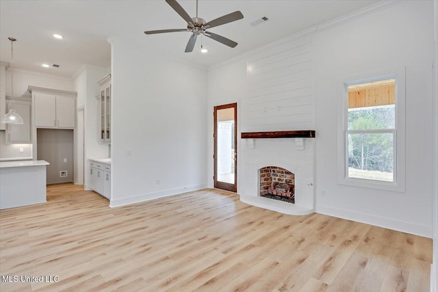 961 Mullican Rd, Florence, MS 39073 - unfurnished living room with crown molding, ceiling fan, a fireplace, light wood-type flooring, and recessed lighting