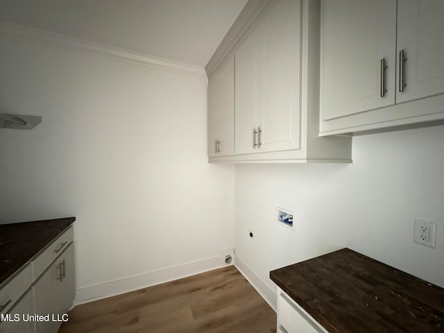 clothes washing area with dark wood-style floors, hookup for a washing machine, cabinet space, ornamental molding, and baseboards