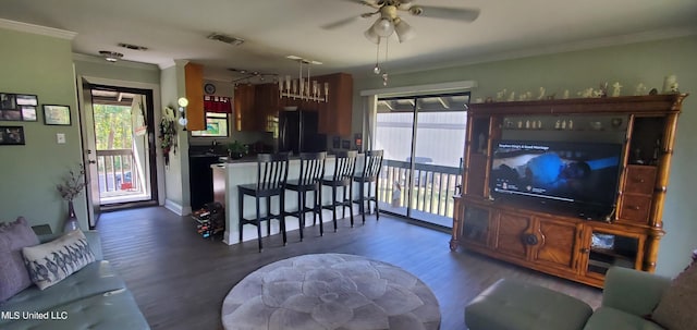 living room with ornamental molding, ceiling fan, and dark hardwood / wood-style flooring