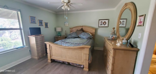 bedroom with ornamental molding, wood-type flooring, and ceiling fan