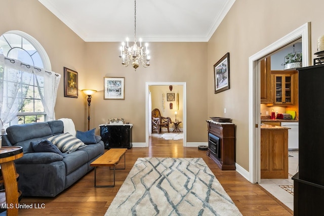 living room featuring dark hardwood / wood-style flooring, ornamental molding, and an inviting chandelier