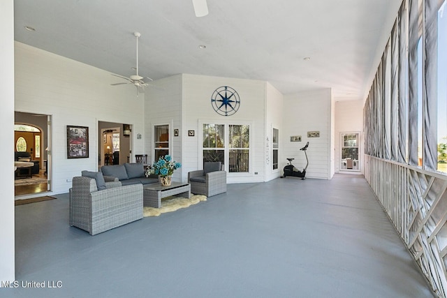 living room featuring a high ceiling and ceiling fan