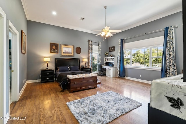 bedroom with light hardwood / wood-style flooring, ceiling fan, and crown molding