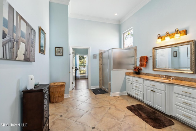 bathroom featuring tile patterned floors, vanity, a shower with door, and a wealth of natural light