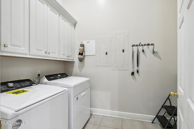 laundry room featuring cabinets, light tile patterned floors, electric panel, and washing machine and clothes dryer