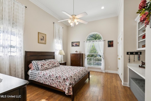 bedroom with ceiling fan, ornamental molding, and hardwood / wood-style flooring