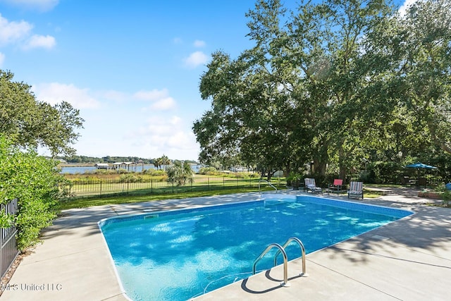 view of pool with a patio area and a water view