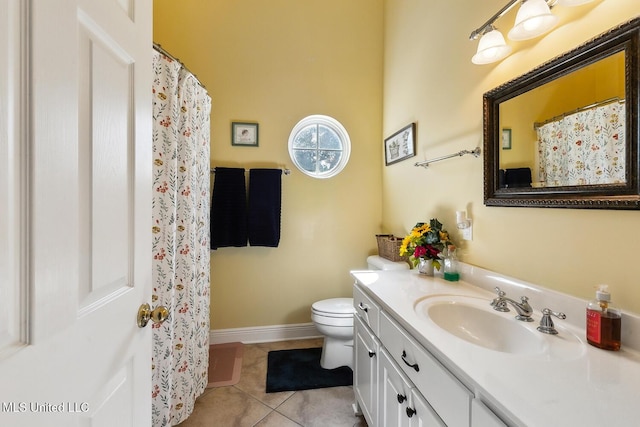 bathroom with tile patterned flooring, vanity, and toilet