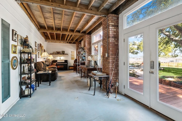 interior space featuring french doors, concrete floors, and wooden ceiling