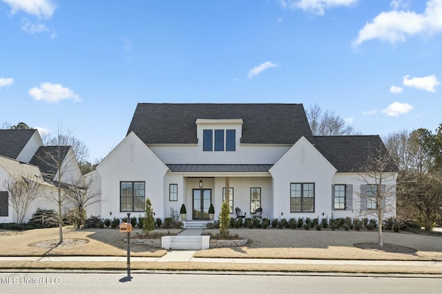 view of front of property with covered porch, metal roof, and a standing seam roof