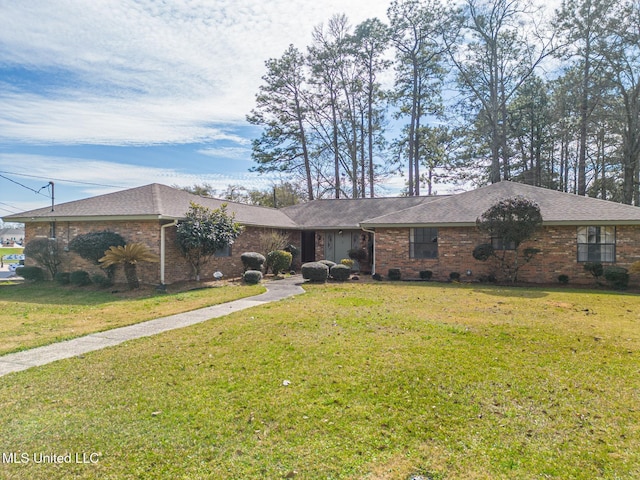 ranch-style home with a shingled roof, crawl space, brick siding, and a front lawn