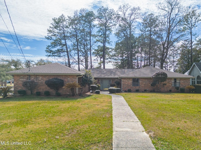 single story home with a shingled roof, a front yard, crawl space, and brick siding