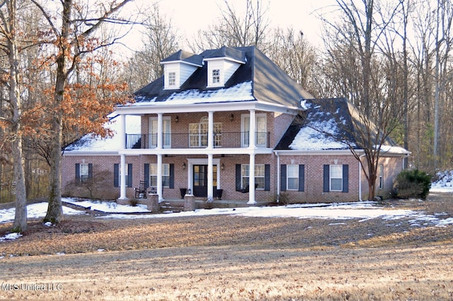 view of front of property featuring a balcony and covered porch