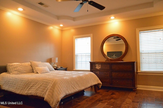 bedroom with a raised ceiling, ceiling fan, ornamental molding, and dark hardwood / wood-style floors