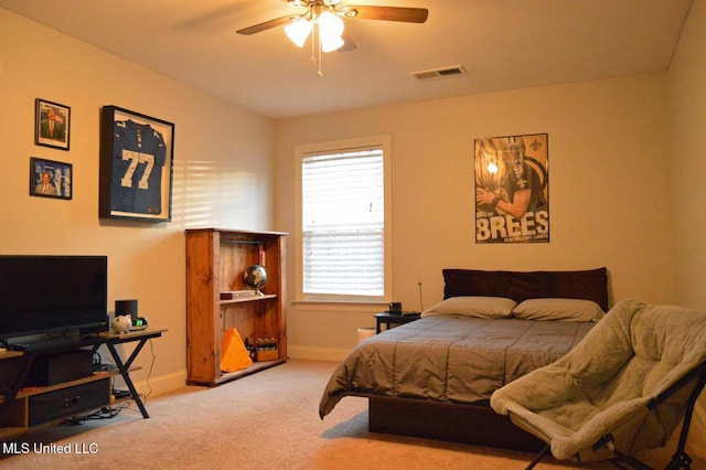 bedroom with multiple windows, ceiling fan, and light colored carpet