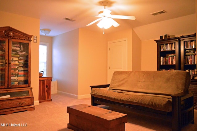 carpeted living room with ceiling fan