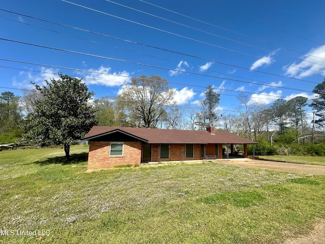 view of front of house featuring a front lawn and a carport