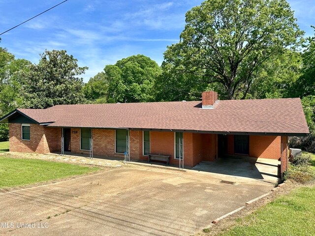 single story home with a carport and a front yard