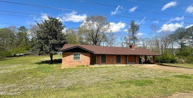 ranch-style house featuring a front lawn and a carport