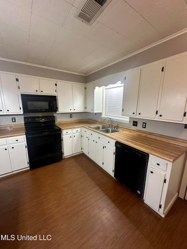 kitchen with sink, black appliances, white cabinets, and dark hardwood / wood-style flooring