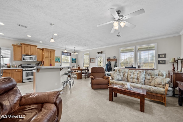 living area featuring a wealth of natural light, visible vents, ceiling fan, and ornamental molding