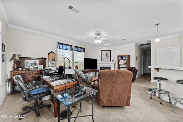 office space featuring crown molding, a ceiling fan, visible vents, and baseboards