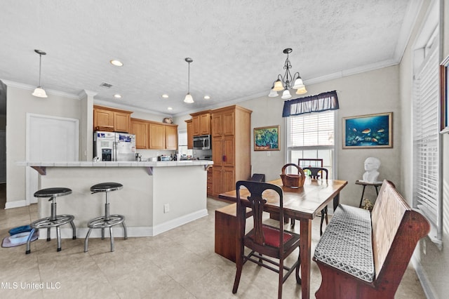 dining space featuring a notable chandelier, recessed lighting, a textured ceiling, and crown molding