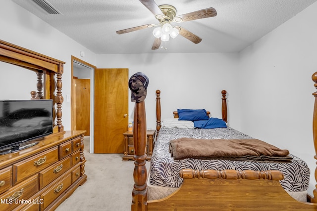 310 John Ave, Pascagoula, MS 39567 - bedroom featuring light carpet, a textured ceiling, and a ceiling fan