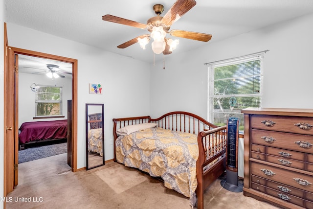 310 John Ave, Pascagoula, MS 39567 - bedroom with light carpet, multiple windows, and ceiling fan