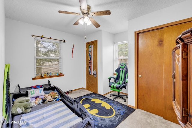 310 John Ave, Pascagoula, MS 39567 - bedroom with carpet floors, a ceiling fan, baseboards, and a textured ceiling