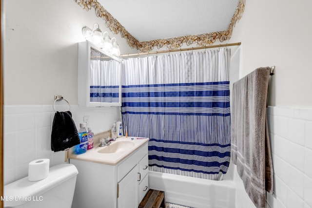 310 John Ave, Pascagoula, MS 39567 - bathroom with tile walls, vanity, shower / tub combo with curtain, toilet, and a wainscoted wall