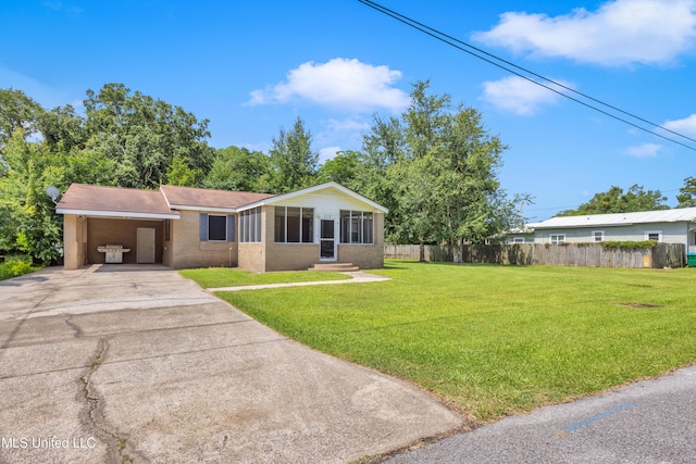 310 John Ave, Pascagoula, MS 39567 - view of front facade with concrete driveway and an attached carport