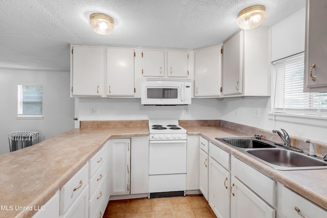 310 John Ave, Pascagoula, MS 39567 - kitchen with white appliances, radiator heating unit, a sink, a textured ceiling, and light countertops