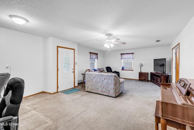 310 John Ave, Pascagoula, MS 39567 - carpeted living room with ceiling fan, a textured ceiling, and baseboards